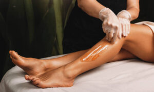 Young caucasian girl having epilation procedures with sugar at spa salon - Face and Body Institute